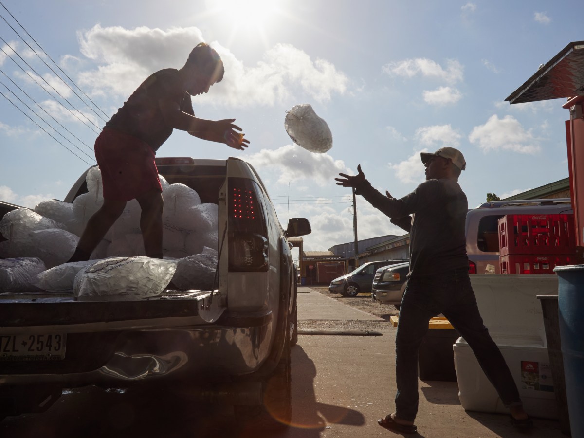 Two men deliver ice to vendors throughout Sunny’s Flea Market