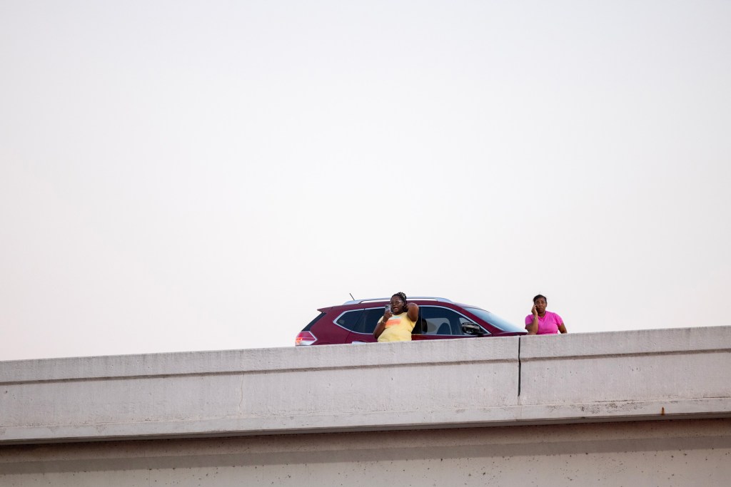 Onlookers watch a police standoff in northeast Harris County.