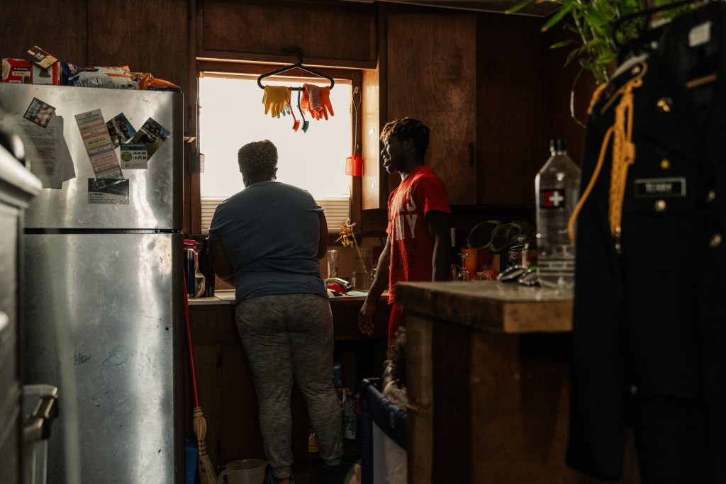 Latreise Berry and her son, Kamden Terry, 17, exchange laughs inside their kitchen in Houston
