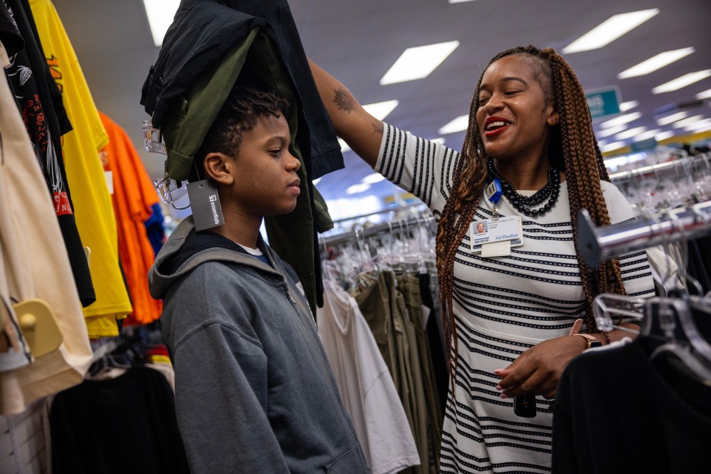 Lianna White jokes around with her son Kyle as they shop for new clothing at Citi Trends in Houston