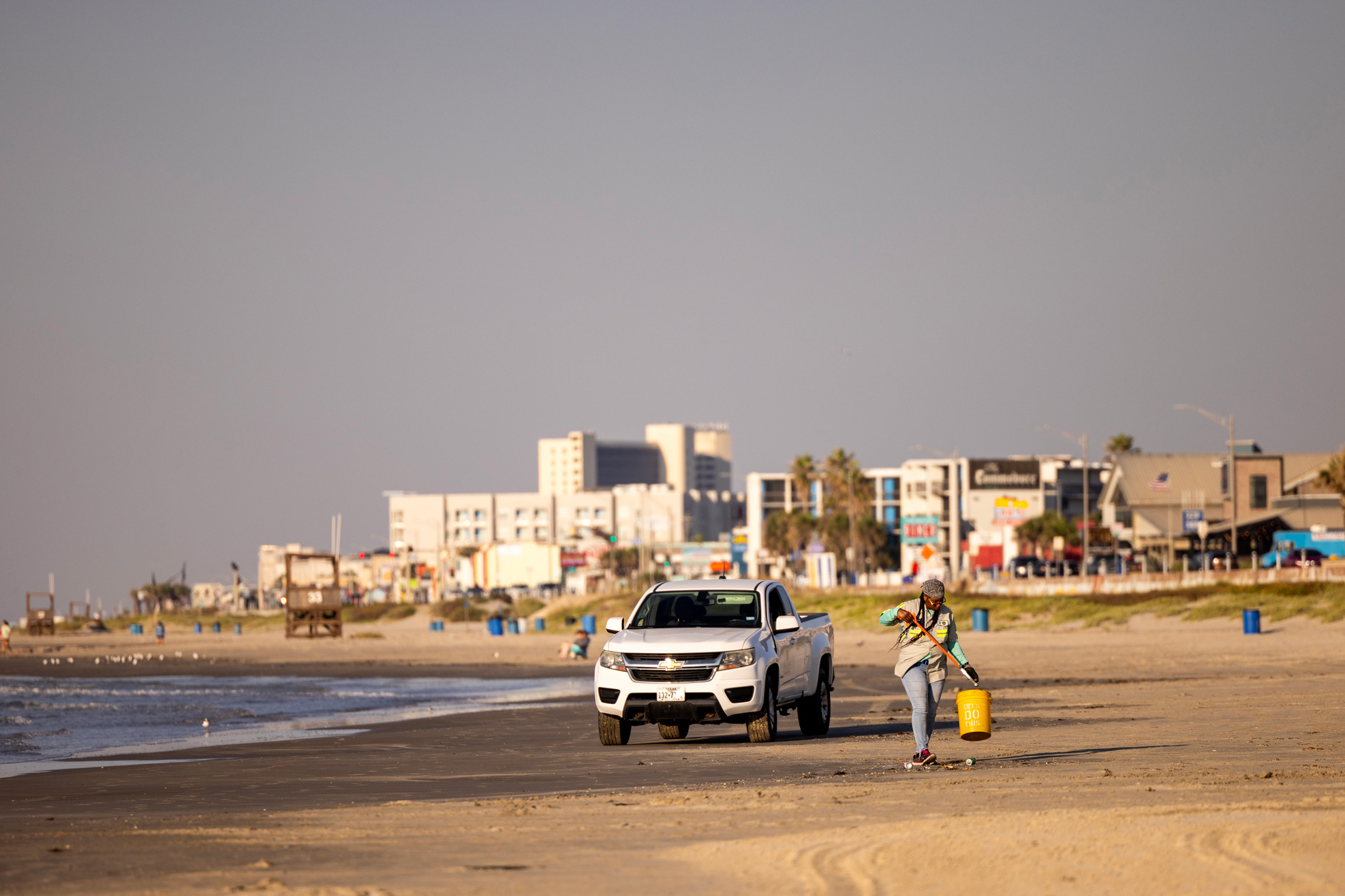 Freda Johnson, a beach technician for the Galveston Island Park Board of Trustees, picks up litter along Galveston Beach