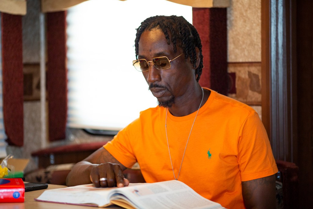 Tommy Taylor reads in his RV