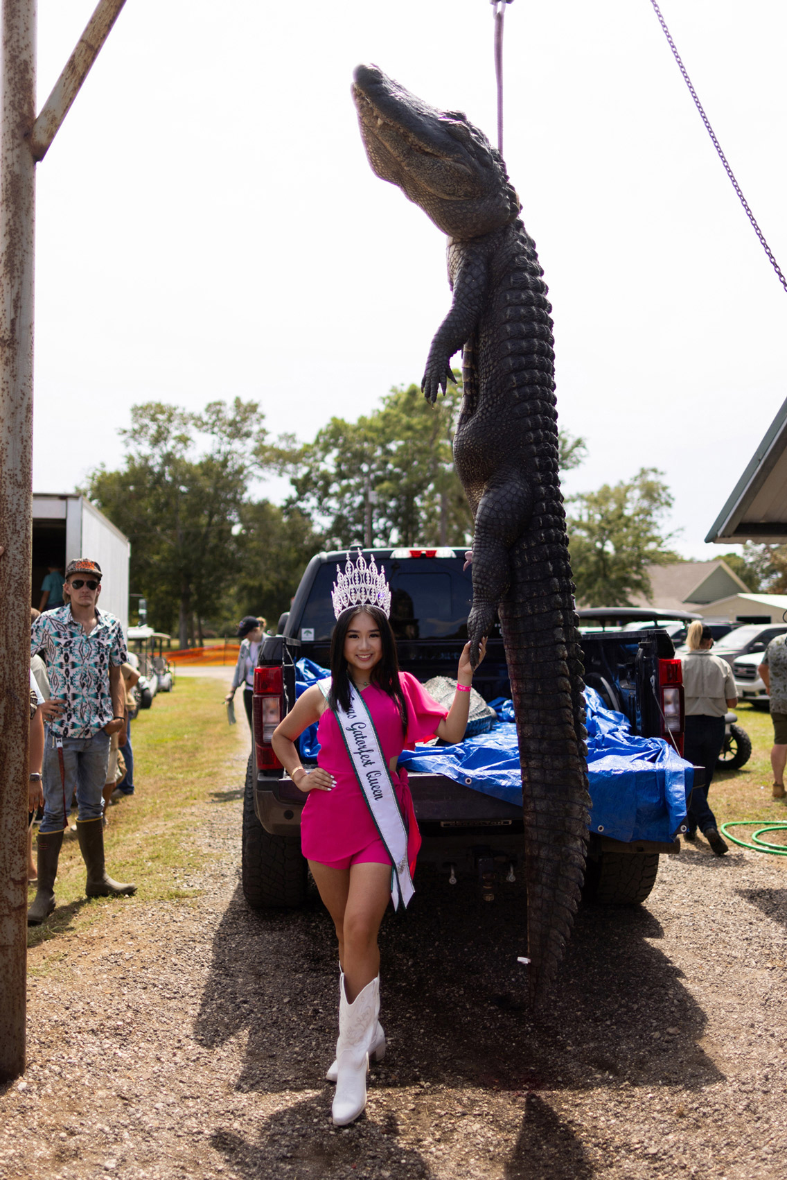 The 2023 Texas Gatorfest Queen Tina Ly, 16, poses with an alligator during Anahuac's annual Gatorfest
