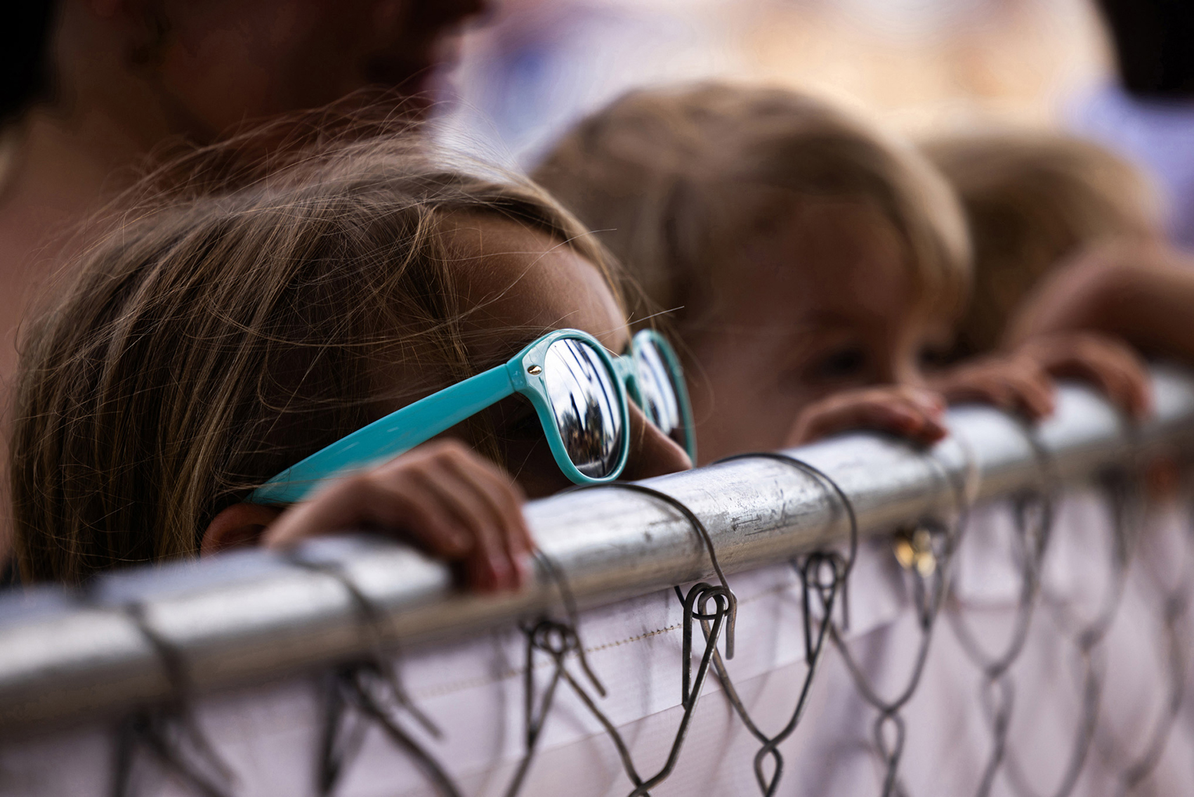 Children peek over a fence to see the hunted alligators arriving to The Great Texas Alligator Roundup