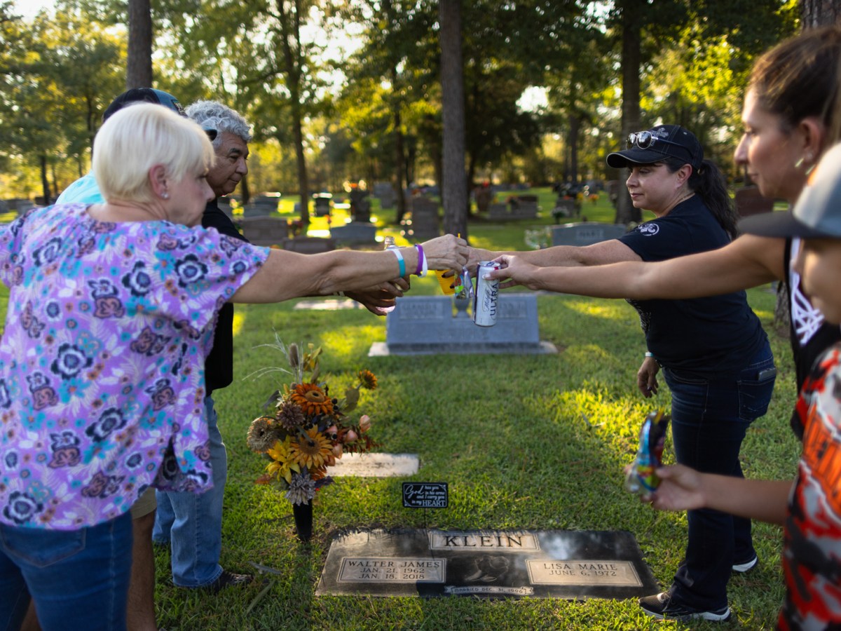 Debbie and Jaime Chapa (left) join Lisa Klein and Jaime and Connor Newton in toasting Lisa's late husband, Walt at his graveside in September. Walt died in 2018 following a heart attack at the Harris County Jail. His death was never reported to the state.