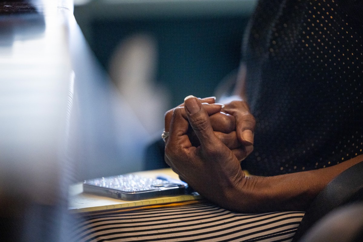 Tanisha Moore clasps her hand together as she speaks about her late son Dexter Ceasar during an interview about his death in Houston.