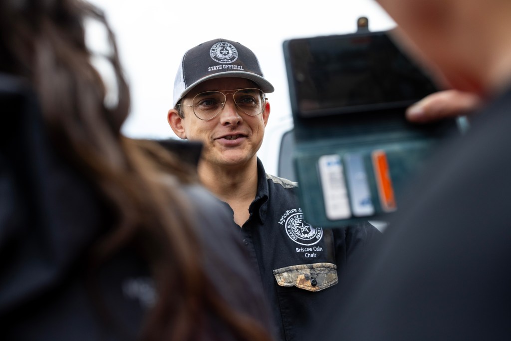 State Rep. Briscoe Cain answers questions from reporters after taking a tour of the Colony Ridge development with other Texas legislators and staff.