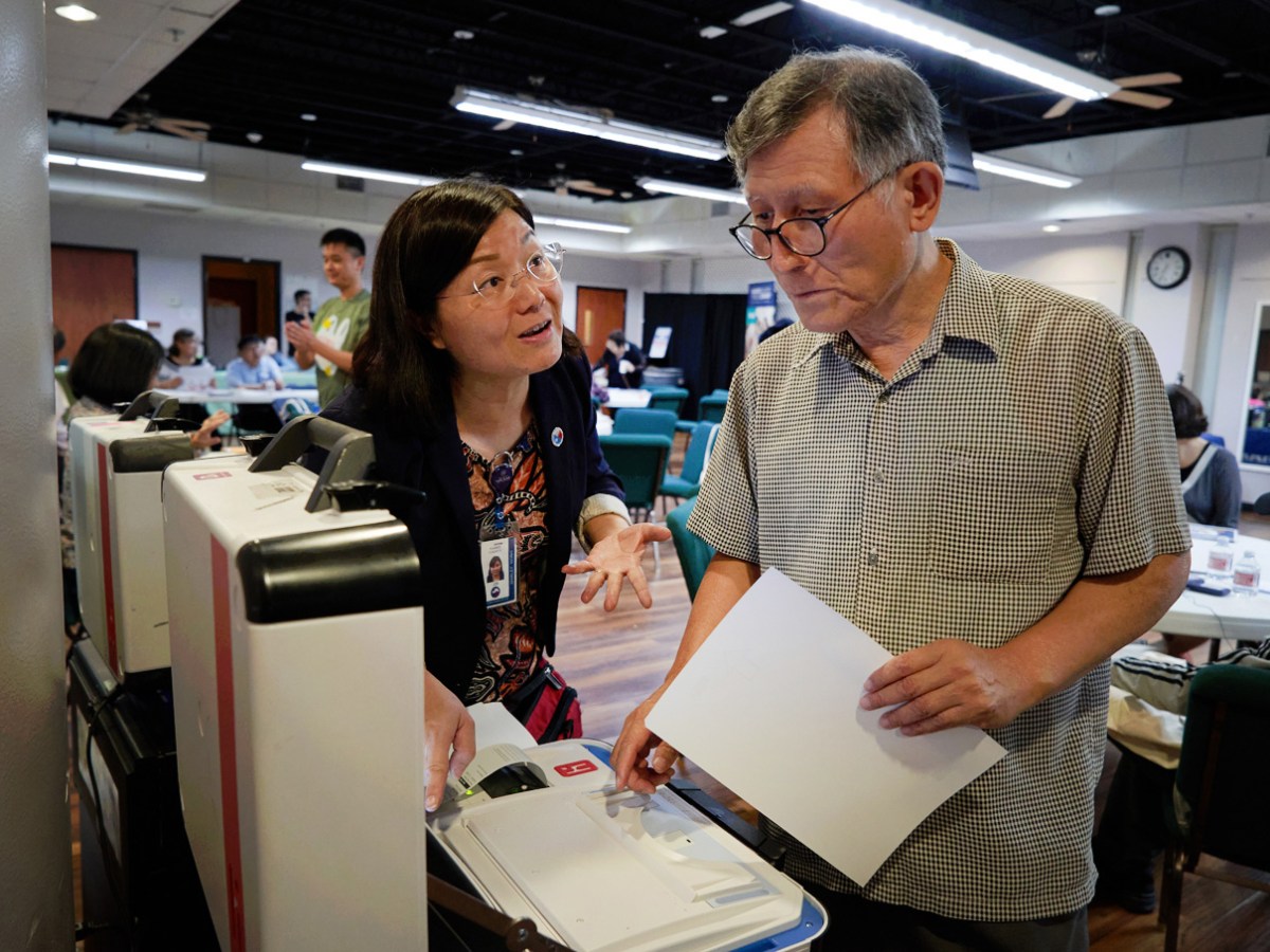 Harris County Election Administration’s Shirley Wong helps Woori Juntos volunteer Paul Kim understand voting machines ahead of the upcoming elections during a forum at the Korean Community Center, Thursday, Oct. 5, 2023, in Houston.