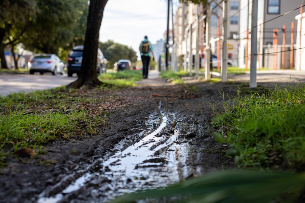 A muddy section of sidewalk on the west side of Montrose Boulevard north of Clay Street