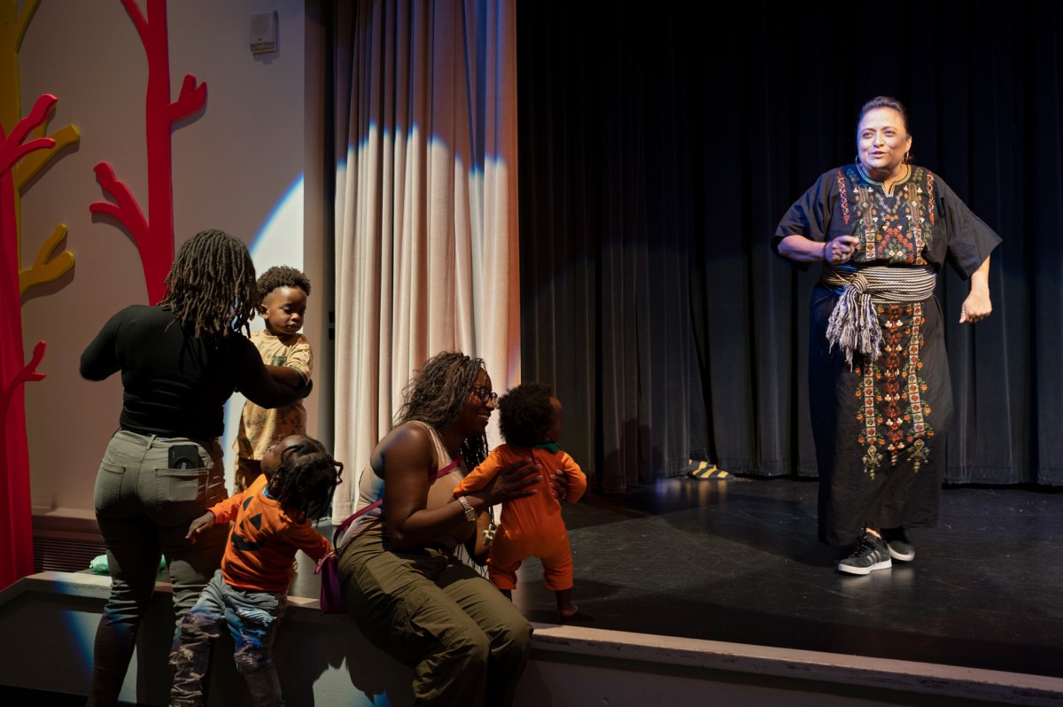 Angela Sanchez de Bravo, right, who is a member of the Calmecac Indigenous organization, sings to audience members during the Indigenous People's Day commemoration at the Children’s Museum