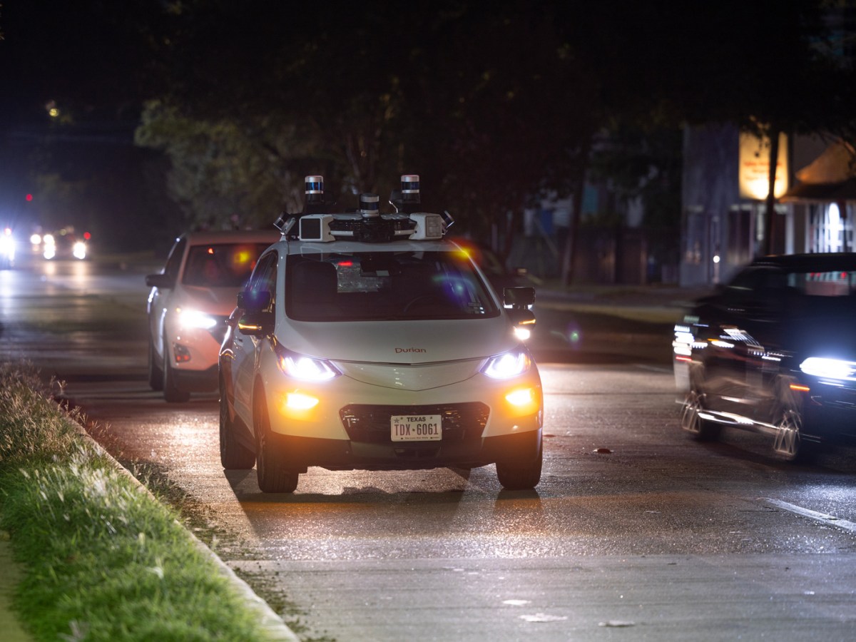 Cars pass by a Cruise vehicle as it waits on "pick-up standby" on Richmond Avenue in October in Houston
