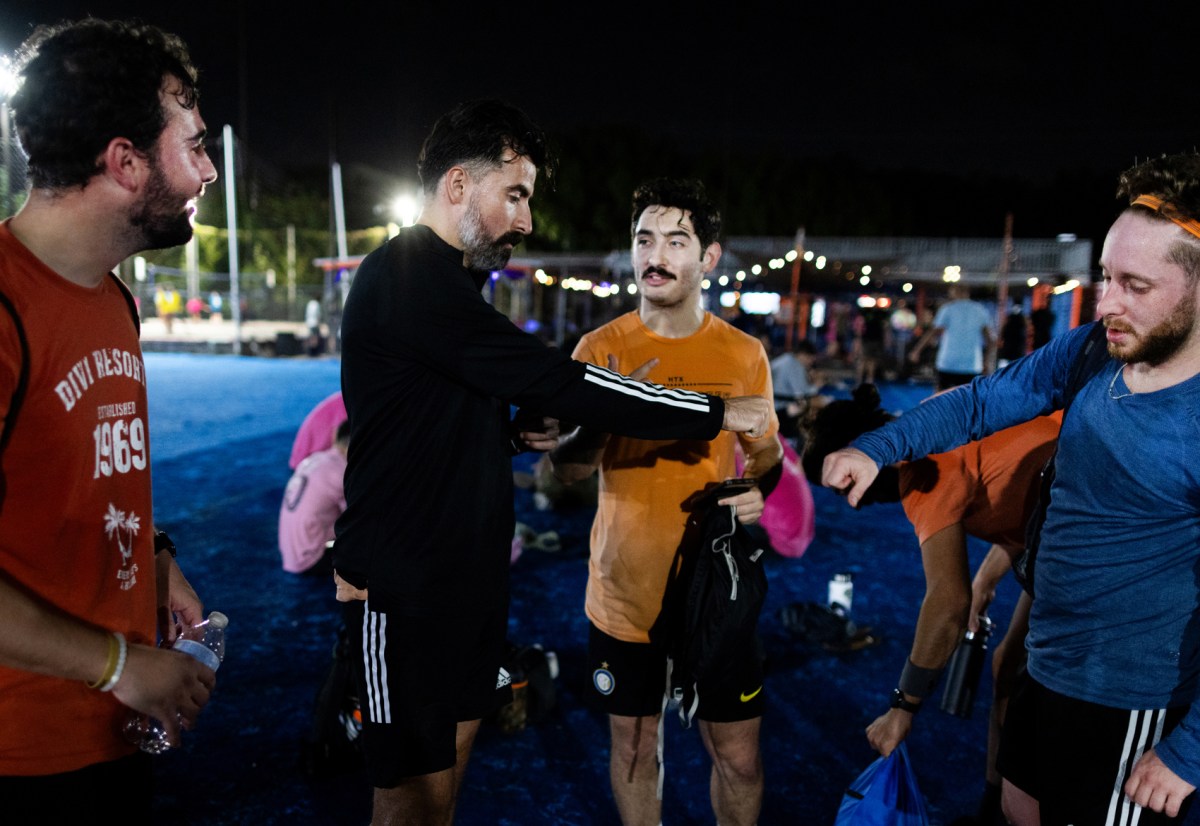 Juan Vega, center, 29, fist bumps with teammate Jack Ciampi, right, 27, after a soccer game, Wednesday, Oct. 25, 2023, in Houston.