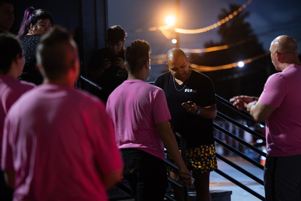 Q Patrol members share business cards with people enjoying the night-life in Montrose, Friday