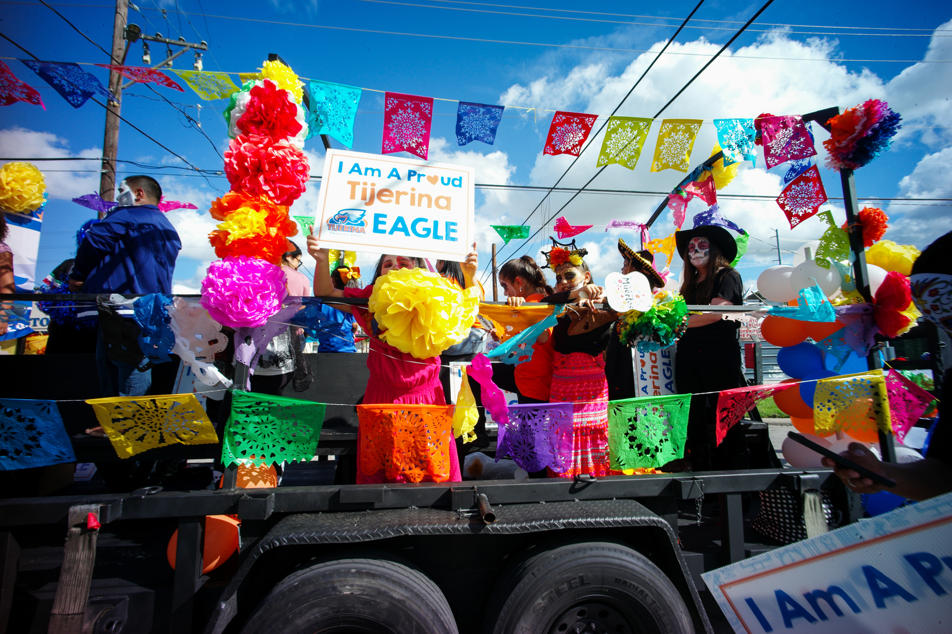 Tijerina Elementary students ride on a trailer in the Dia de los Muertos parade, Saturday, Oct. 28, 2023, in Houston.