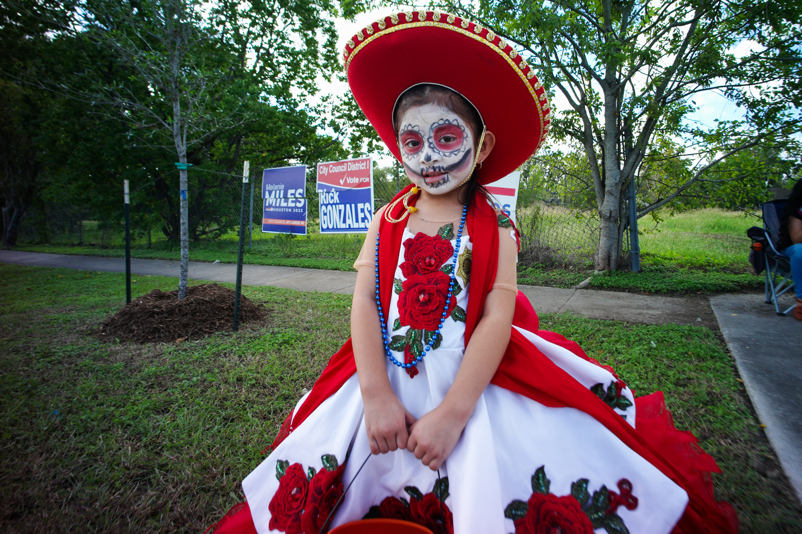 Abigal Garcia stands near the road to watch the Dia de los Muertos parade, Saturday, Oct. 28, 2023, in Houston. Abigal’s father joked that his daughter looked “front page” worthy. 