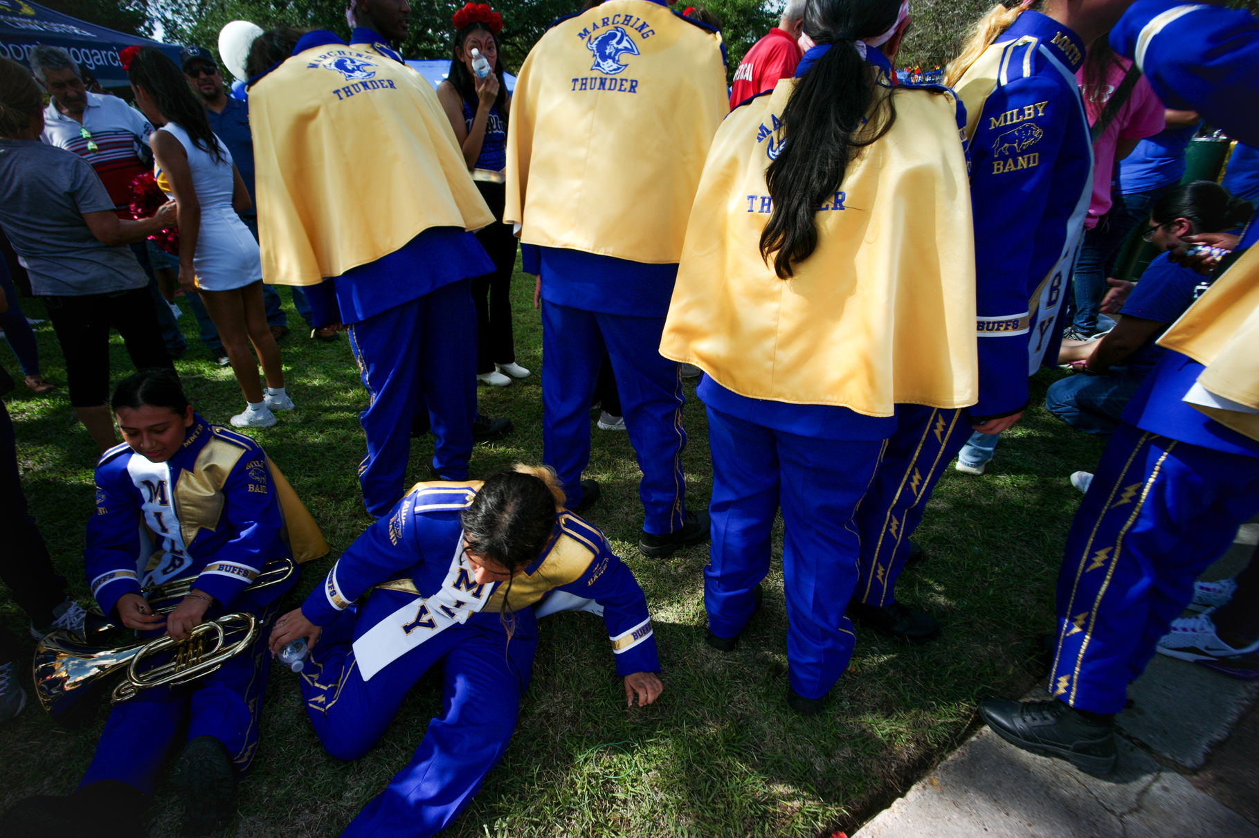 Students in the Milby High School marching band rest after participating in the Dia de los Muertos parade, Saturday, Oct. 28, 2023, in Houston.