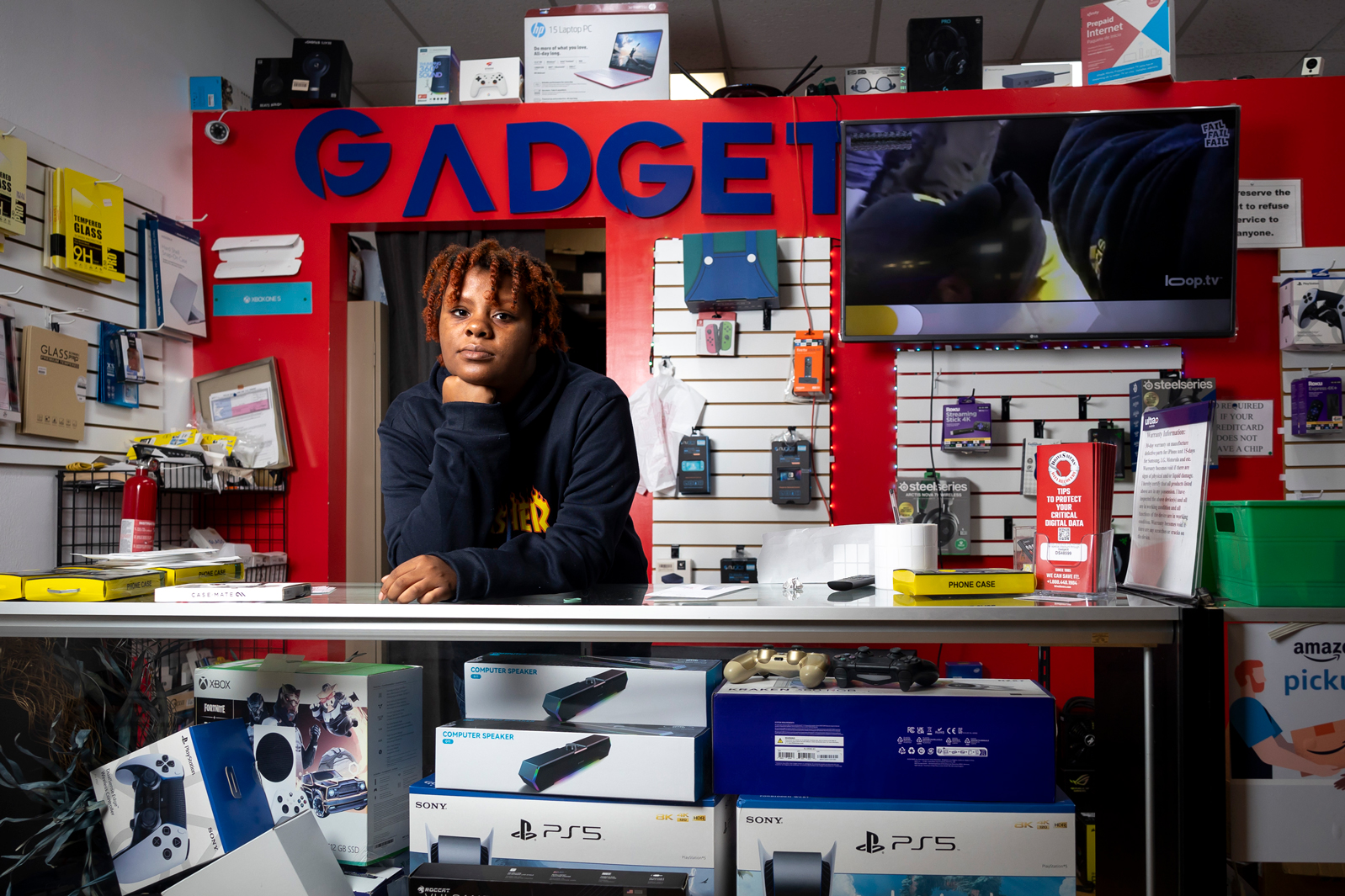 Khalil Nikolas Daniels, 16, in their dad’s electronics shop