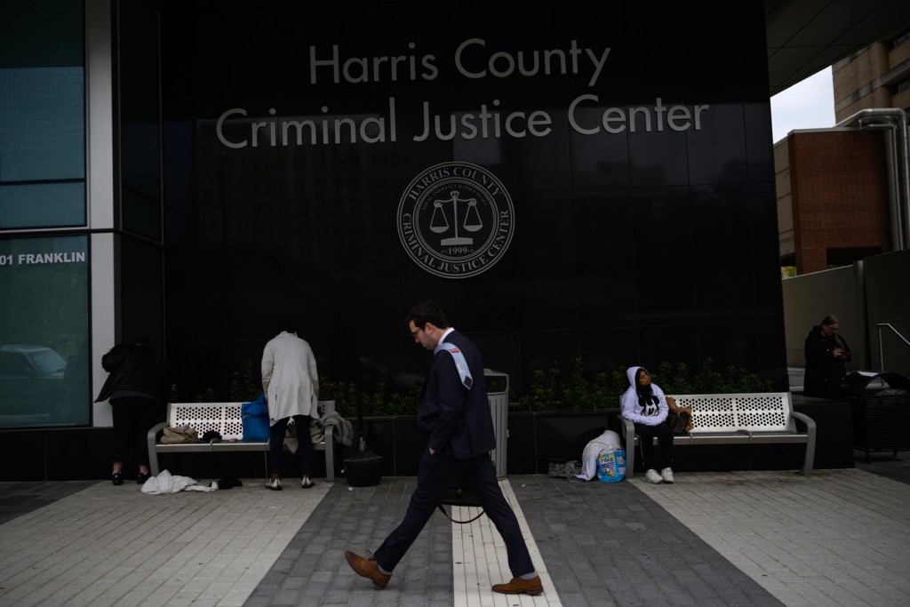 A person walks past the Harris County Criminal Justice Center