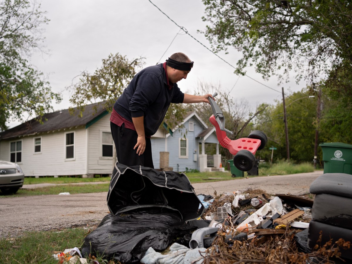 Edward D. Pettitt II sifts through a trash pile on an empty Midtown Redevelopment Authority lot located in the Third Ward neighborhood of Houston, Texas.