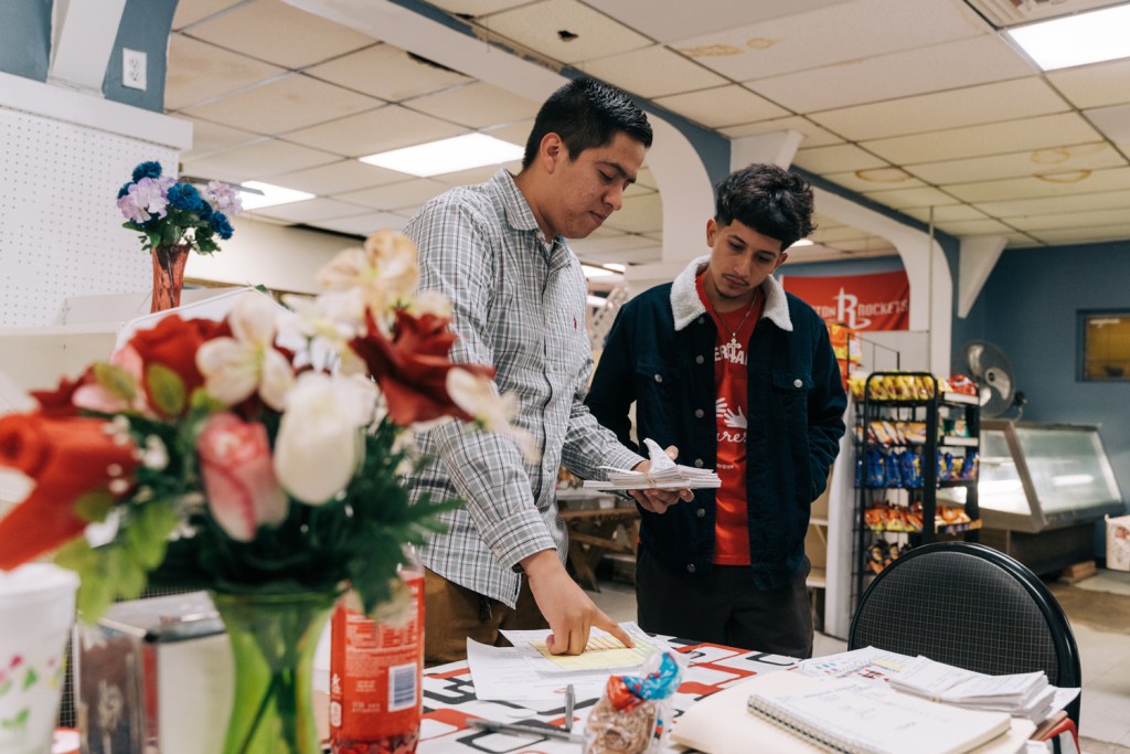 On the left, Ryan Martinez of Denver Harbor Cares explains block walking to Anthony Vallecillo, a volunteer