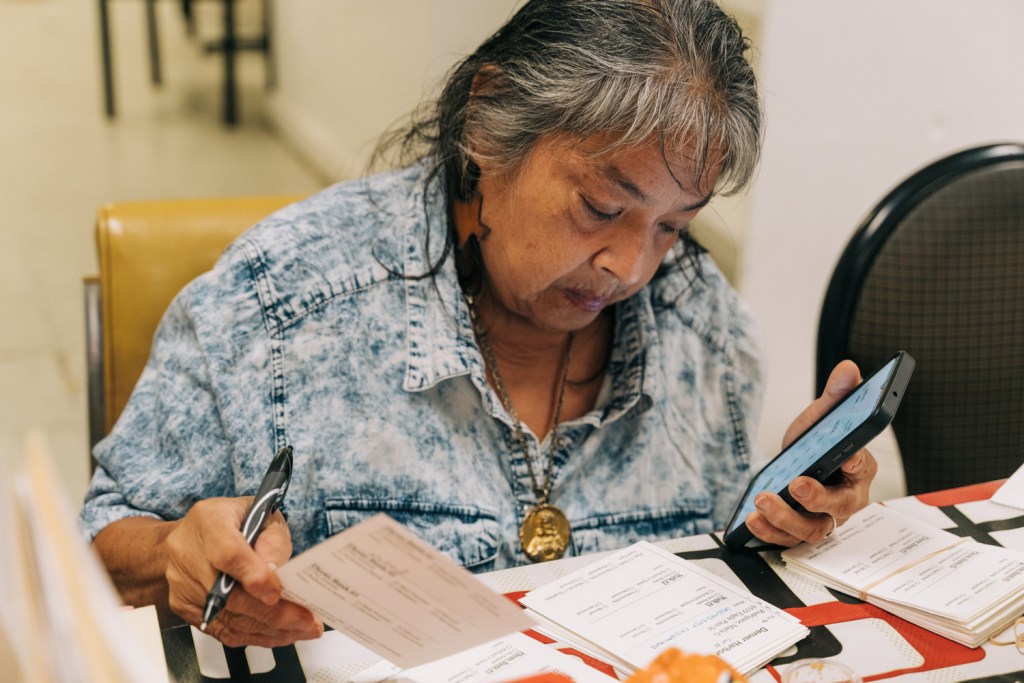 Rita Rocha Shattah, a Denver Harbor Cares’ volunteer, checks off callers from phone banking to vote on Wednesday