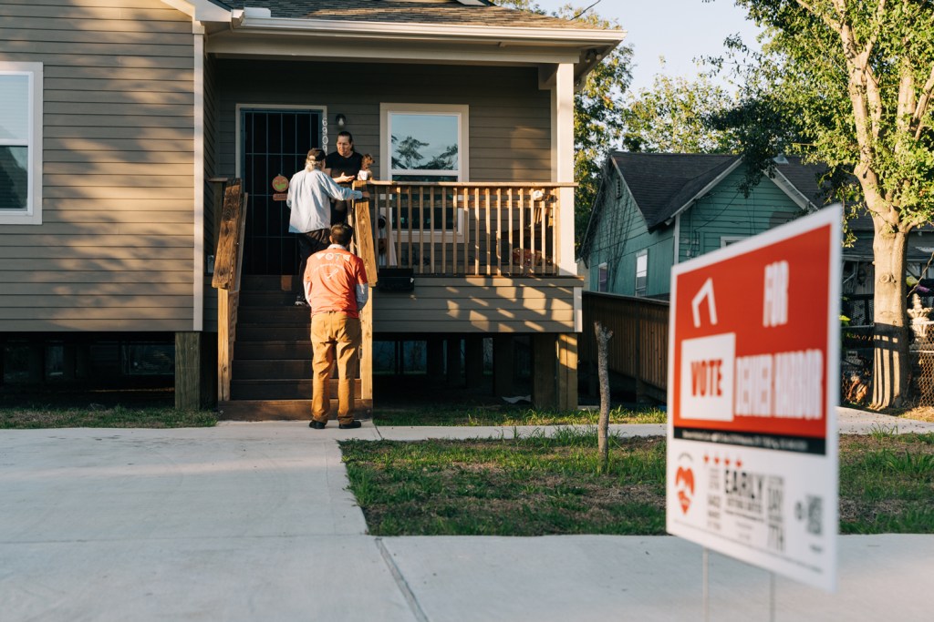 Rene Porras and Ryan Martinez of Denver Harbor Cares speak with Martha Rodriguez during a block walk in Houston