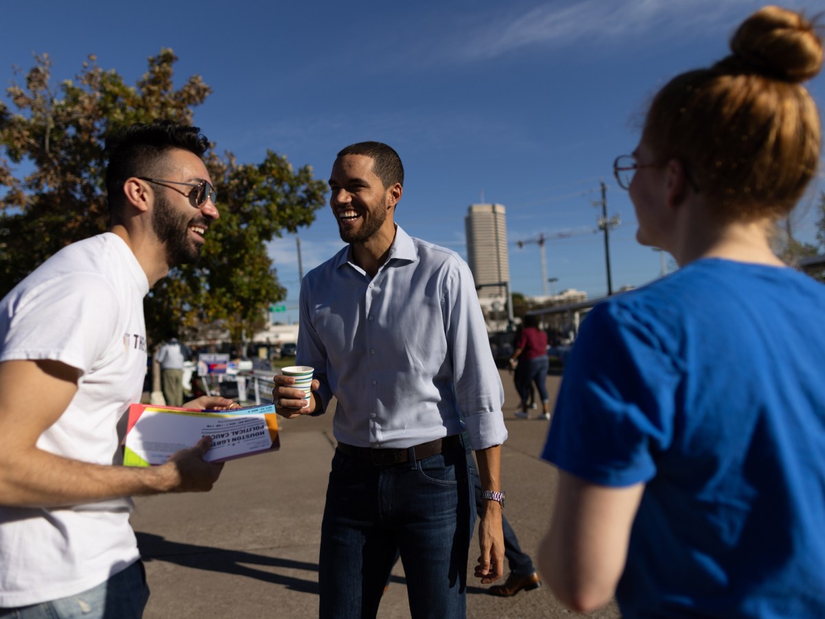 Houston City Controller. Candidate Chris Hollins, center, talks to people at the Houston Metropolitan Multi-Service Center on Election Day