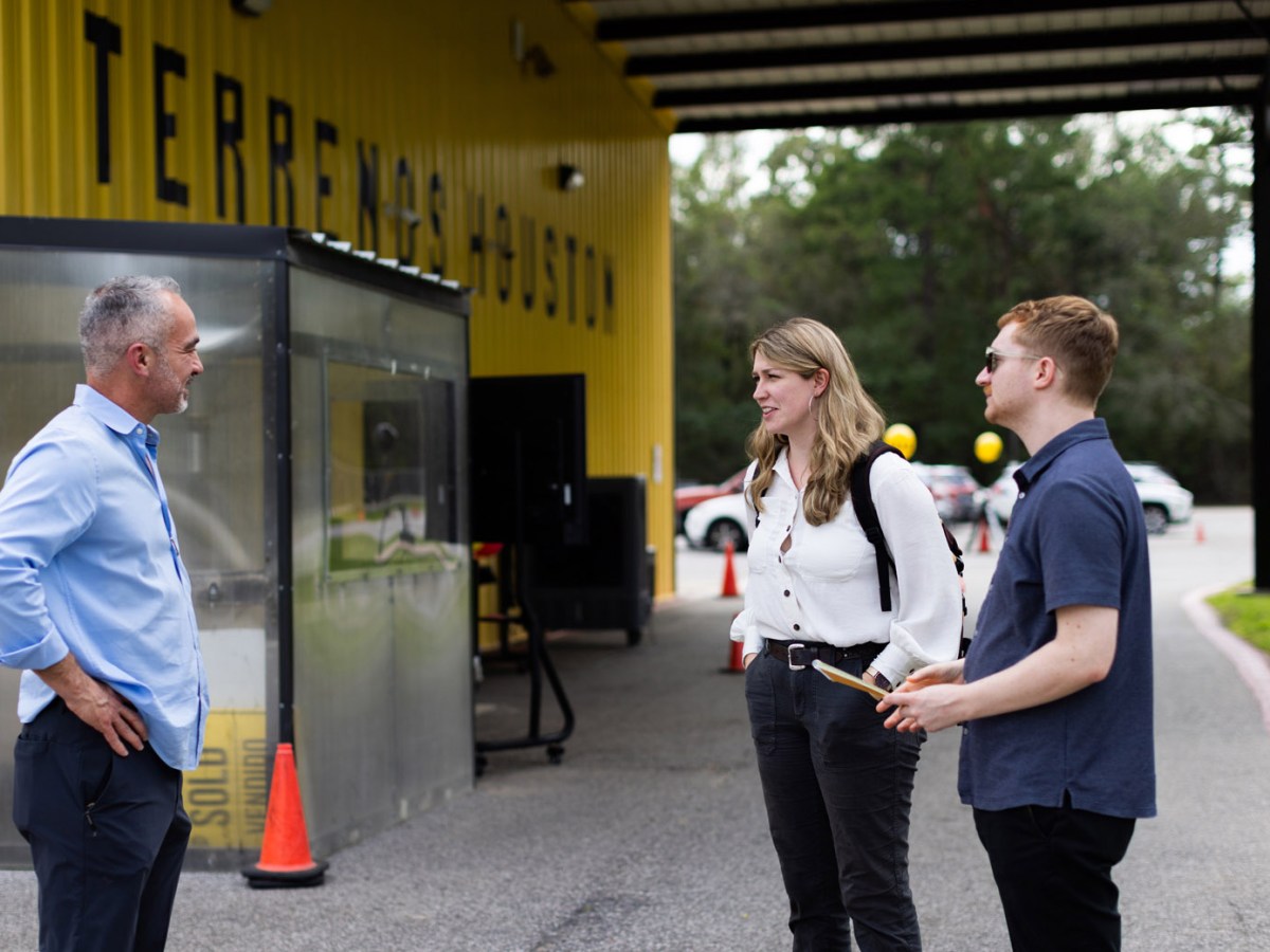 Colony Ridge developer John Harris, left, speaks with Houston Landing reporters Céilí Doyle, center, and Monroe Trombly, right, during an interivew.