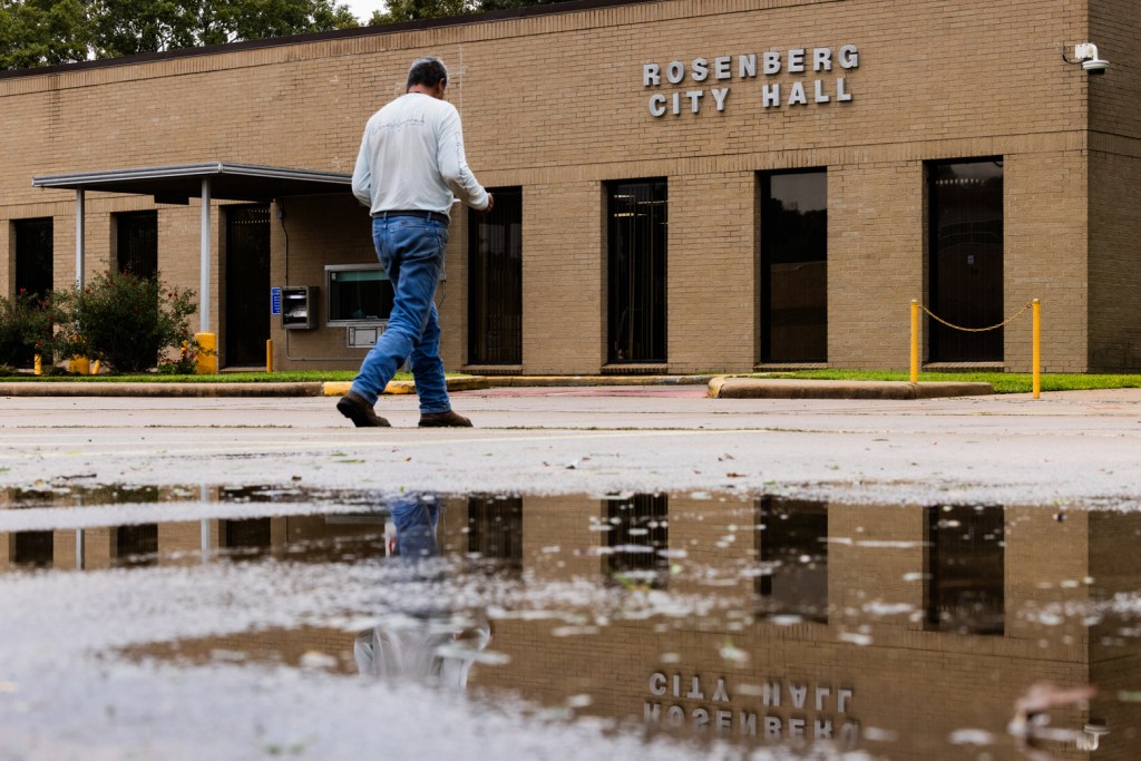 A person walks to the Rosenberg City Hall