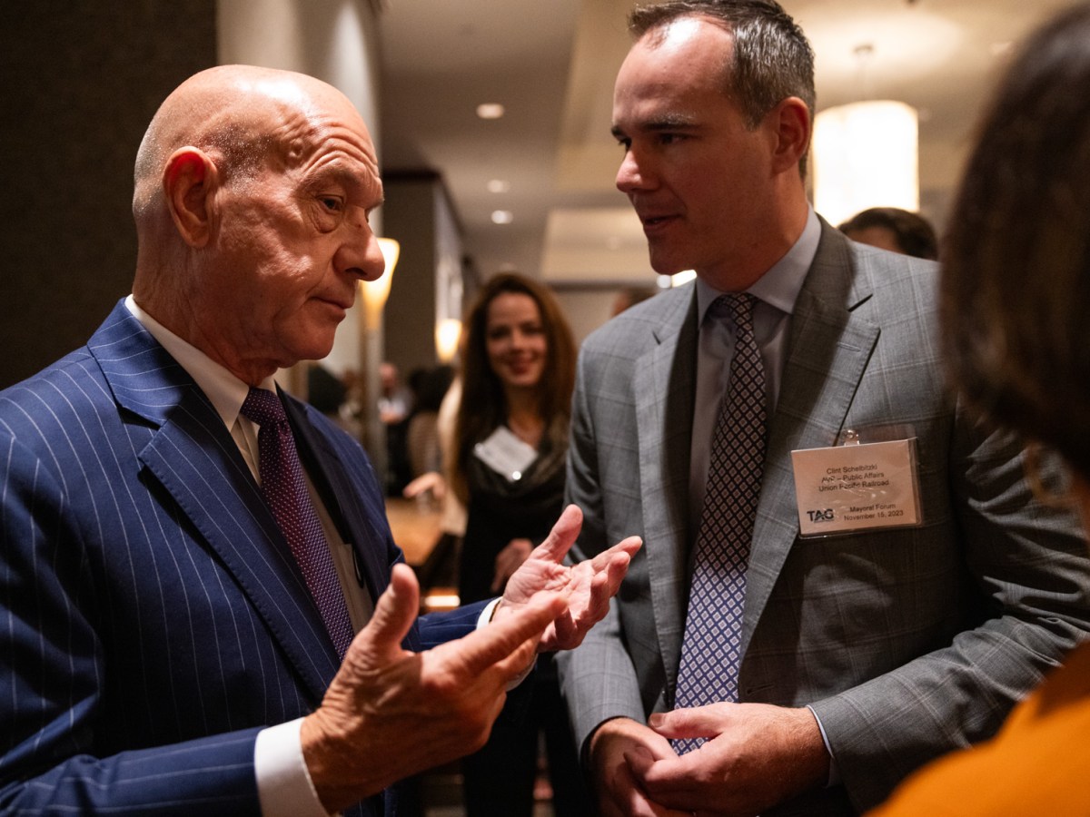 Mayor John Whitmire (A mayoral candidate in this photo), at left, speaks to Clint Schelbitzki, Assistant Vice President of Public Affairs at Union Pacific Railroad, at right, during a forum hosted by the Transportation Advocacy Group - Houston at The Royal Sonesta Houston Galleria