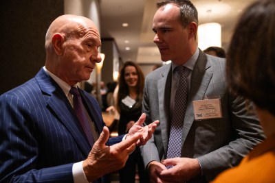 Mayor John Whitmire (A mayoral candidate in this photo), at left, speaks to Clint Schelbitzki, Assistant Vice President of Public Affairs at Union Pacific Railroad, at right, during a forum hosted by the Transportation Advocacy Group - Houston at The Royal Sonesta Houston Galleria
