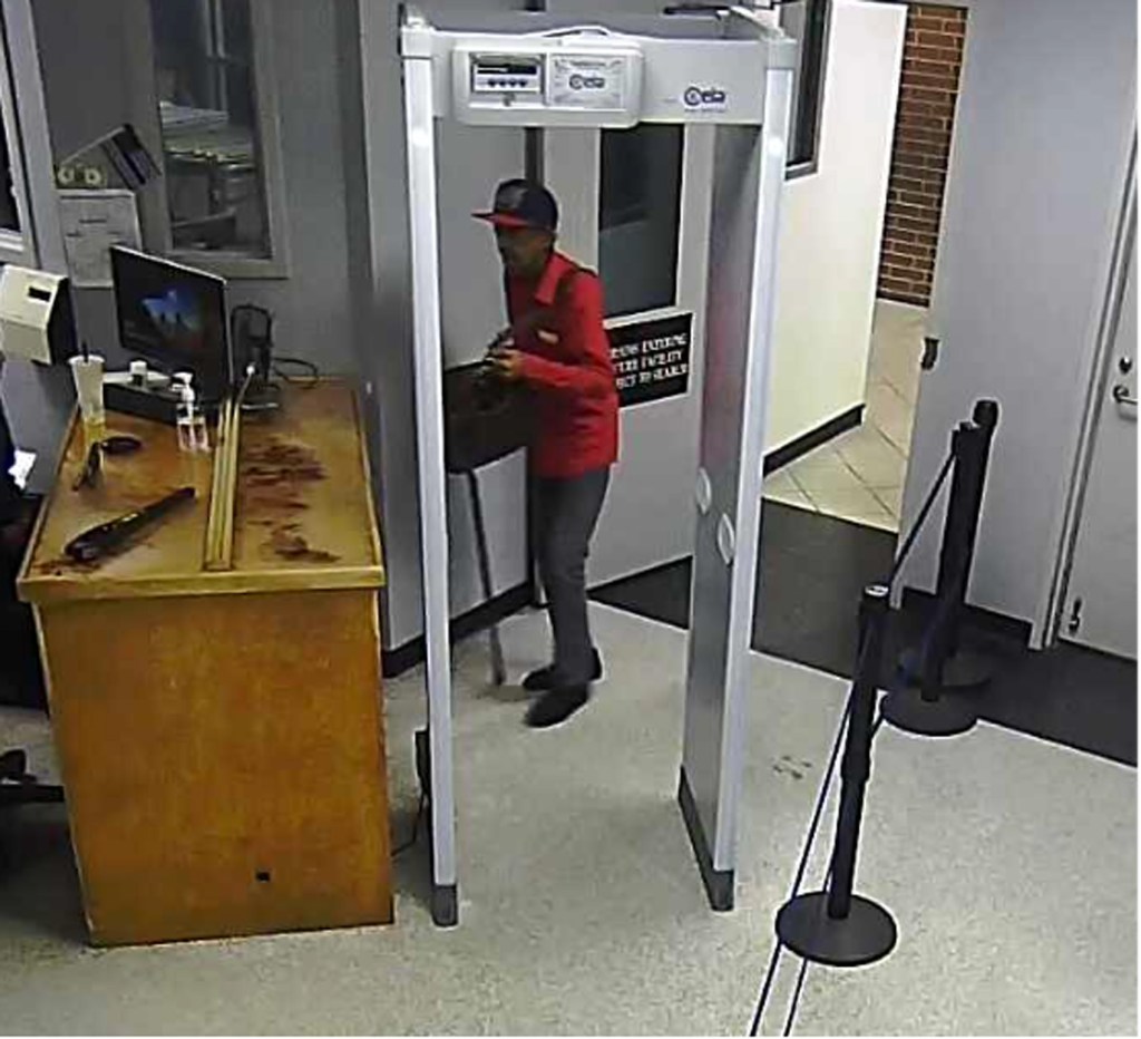 This photo provided by authorities shows Ronald Lewis being processed at the Harris County Jail