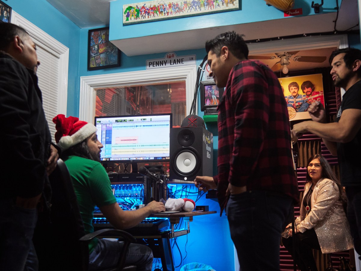 Members of EZ Band record a Christmas song in their backyard studio in Houston.