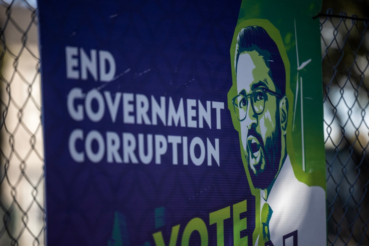 A campaign sign for Congressional candidate Pervez Agwan hangs on a construction site fence on Montrose Boulevard in Houston.