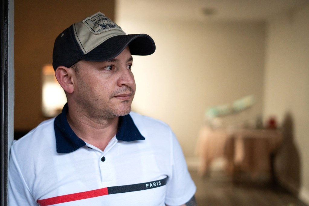 Jesus, a Venezuelan native,  poses for a portrait on the balcony of his Houston home Tuesday in Houston.