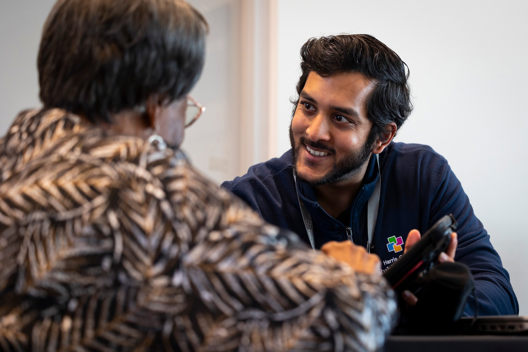 Justin Rahman, outreach program manager for Harris County Public Health, speaks with an applicant about Uplift Harris, a guaranteed income pilot program at the Sunnyside Multi-Service Center