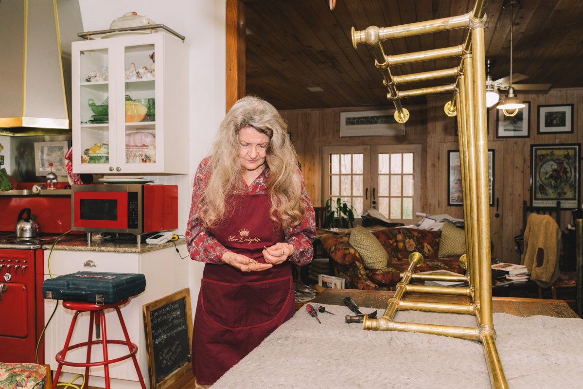 Daphne Scarbrough of The Brass Maiden sorts through nails for fasteners in a brass shelf Friday in Houston. Scarbrough helped collect three rounds of petitions from business owners seeking to have the Montrose Management District dissolved.