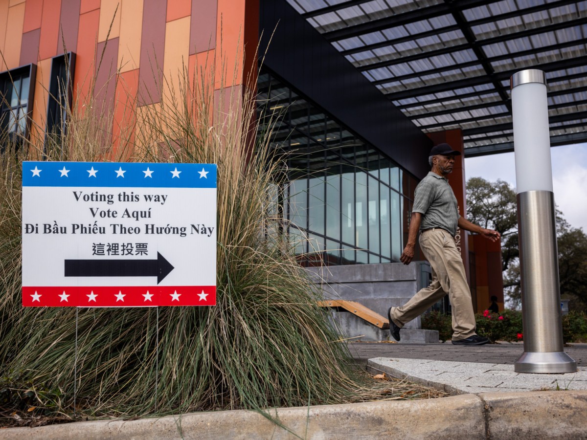 John Wayne Patterson walks past a voting sign on Super Tuesday at Emancipation Park, Tuesday, March 5, 2024, in Houston.