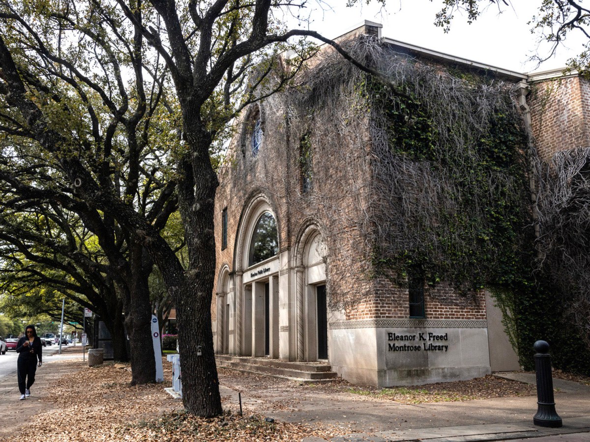 A woman walks past the Freed-Montrose Neighborhood Library, Thursday, March 7, 2024, in Houston.