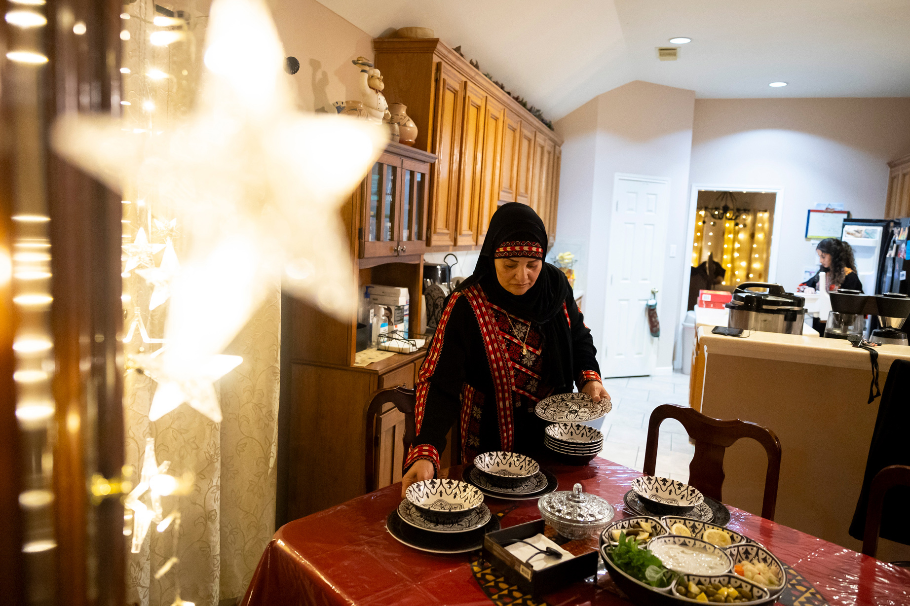 Iman Asfour sets out dishes for iftar in her home on Thursday,
