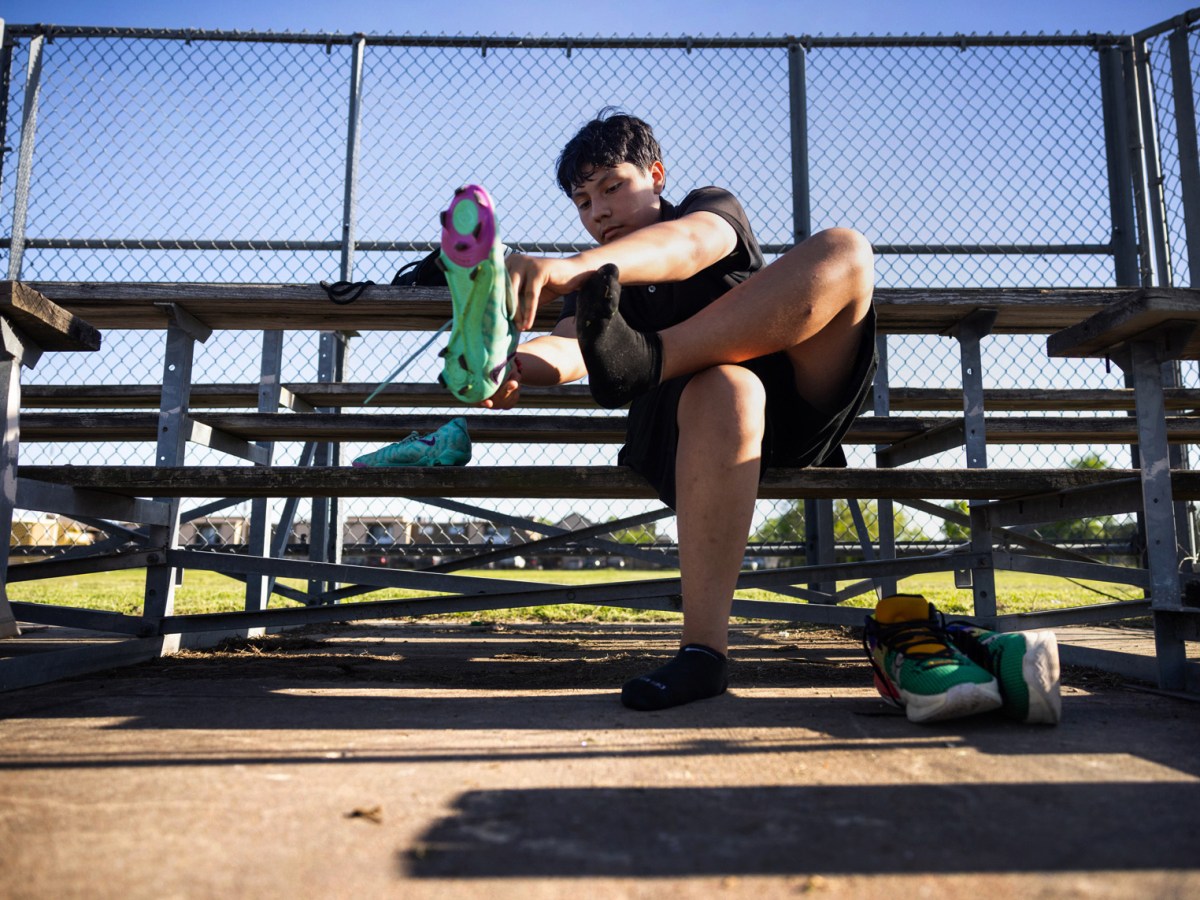 Roberto Hernández, 14, puts on his soccer cleats at Fondren Middle School, Tuesday, March 26, 2024, in Houston.
