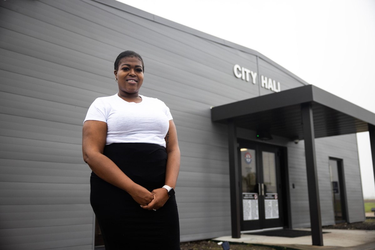 Ebony Sanco, council member, poses for a portrait outside of Arcola City Hall