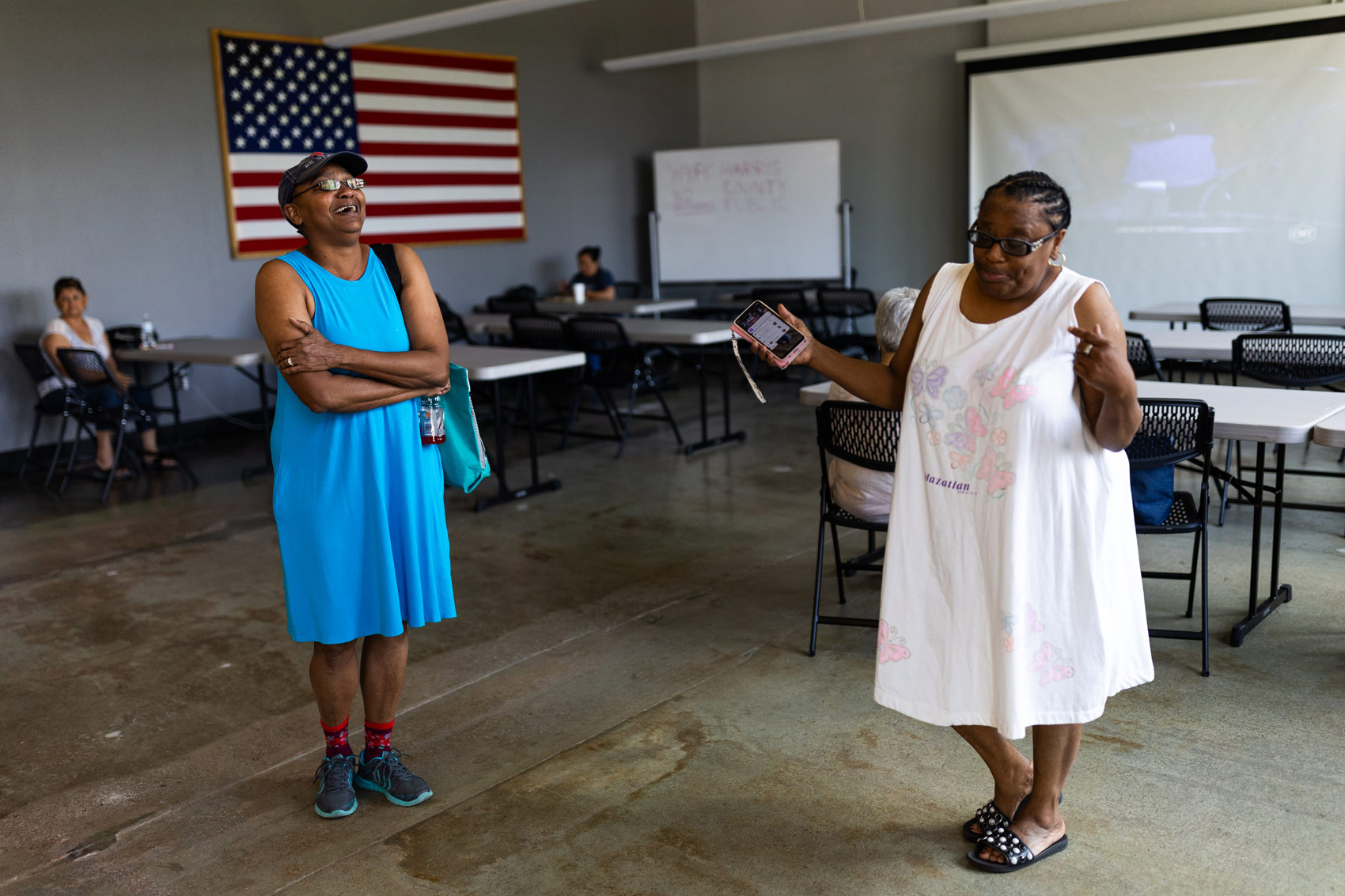 Neighbors Nowell Degree, left, and Kathy Smith, right, spent time cooling off and eating snacks at the cooling center inside the Leonel Castillo Community Center on Sunday, May 19, 2024, in Houston.