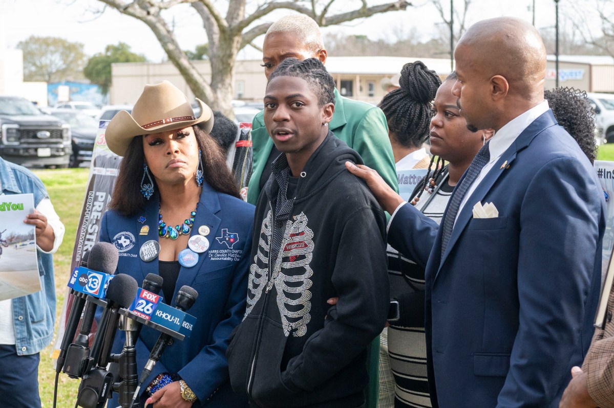 Dr. Candice Matthews, left, listens as state representative Ron Reynolds, right, with Darryl George, center, makes comments before a hearing regarding George's punishment for violating school dress code policy because of his hairstyle, Thursday Feb. 22, 2024 at the Chambers County Courthous in Anahuac, Texas.