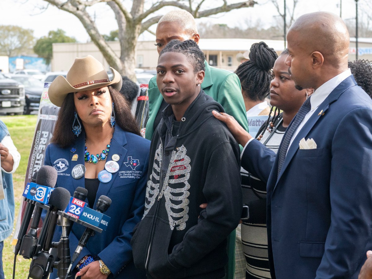Dr. Candice Matthews, left, listens as state representative Ron Reynolds, right, with Darryl George, center, makes comments before a hearing regarding George's punishment for violating school dress code policy because of his hairstyle, Thursday Feb. 22, 2024 at the Chambers County Courthous in Anahuac, Texas.