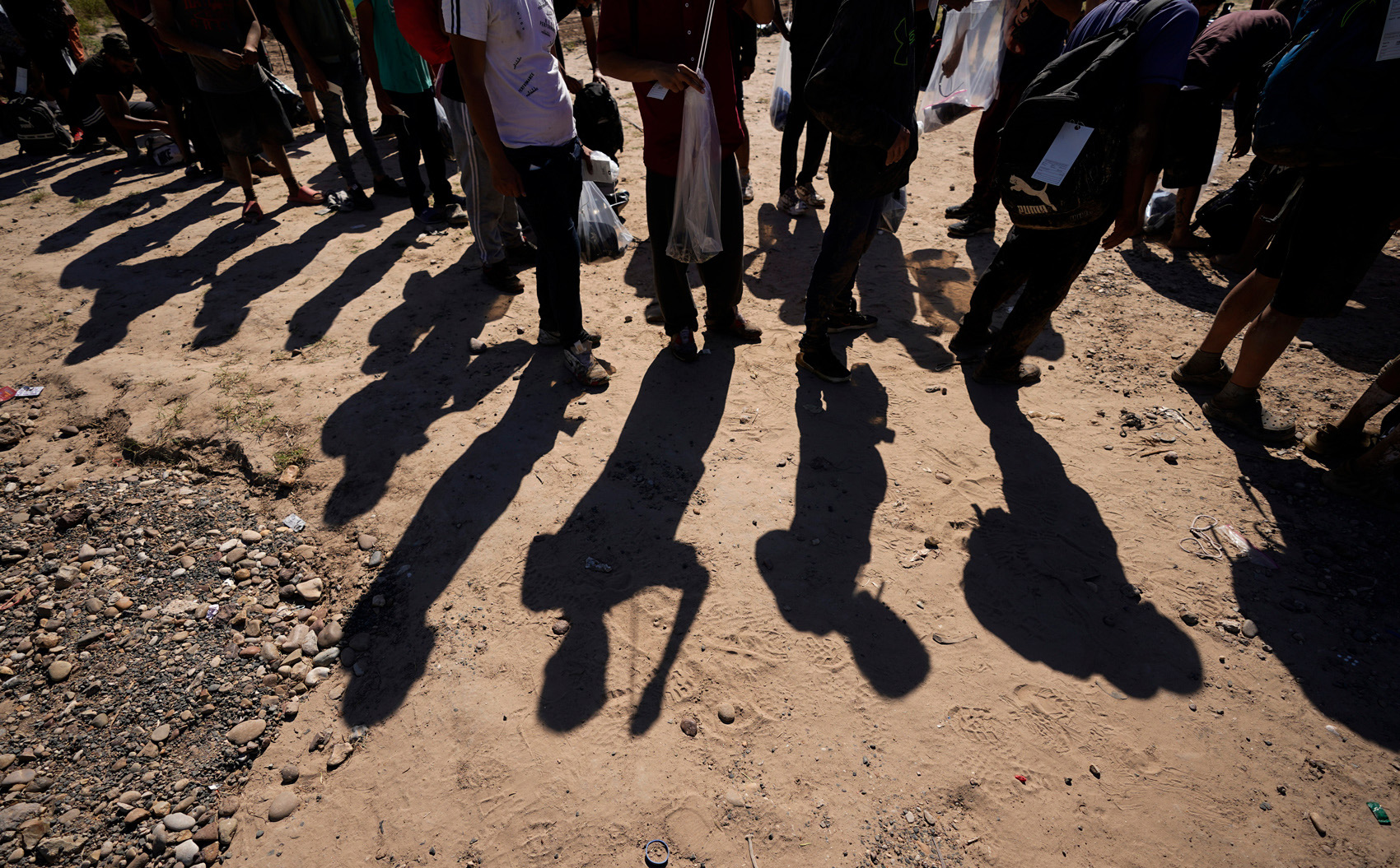 Migrants wait to be processed by the U.S. Customs and Border Patrol after they crossed the Rio Grande and entered the U.S. from Mexico, Oct. 19, 2023, in Eagle Pass, Texas.
