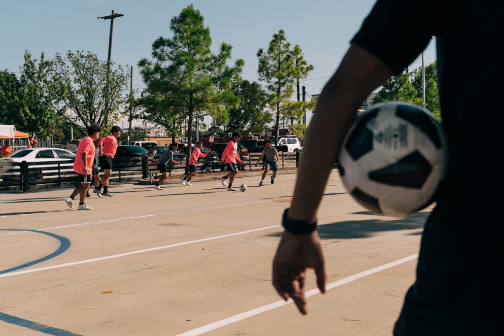 A referee holds a soccer ball as he watches a game on Saturday, Sept. 30, 2023, in Houston.