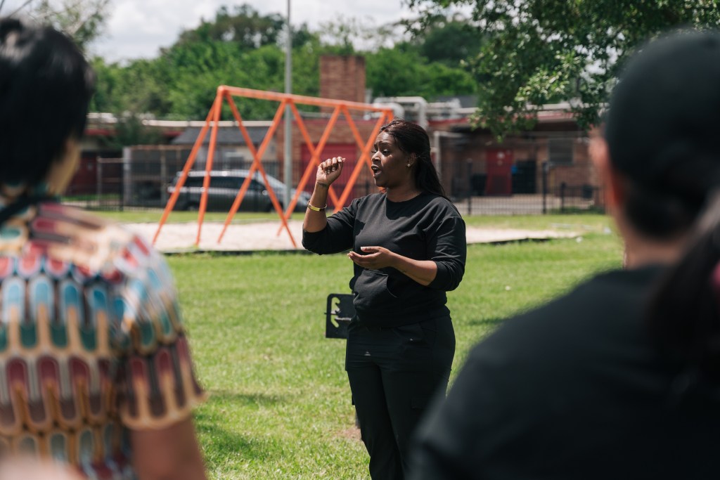 Kendra London, Fifth Ward native and community organizer, speaks with community members