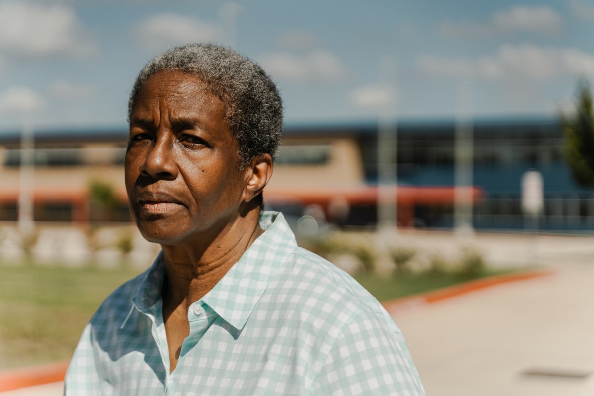 Karen Calhoun, a fifth-grade teacher at Houston ISD's Askew Elementary School, poses for a portrait Saturday outside the campus on HISD's west side. Calhoun said changes pushed by new HISD Superintendent Mike Miles have taken root at Askew, despite comments from Miles suggesting most district campuses would not see significant changes.