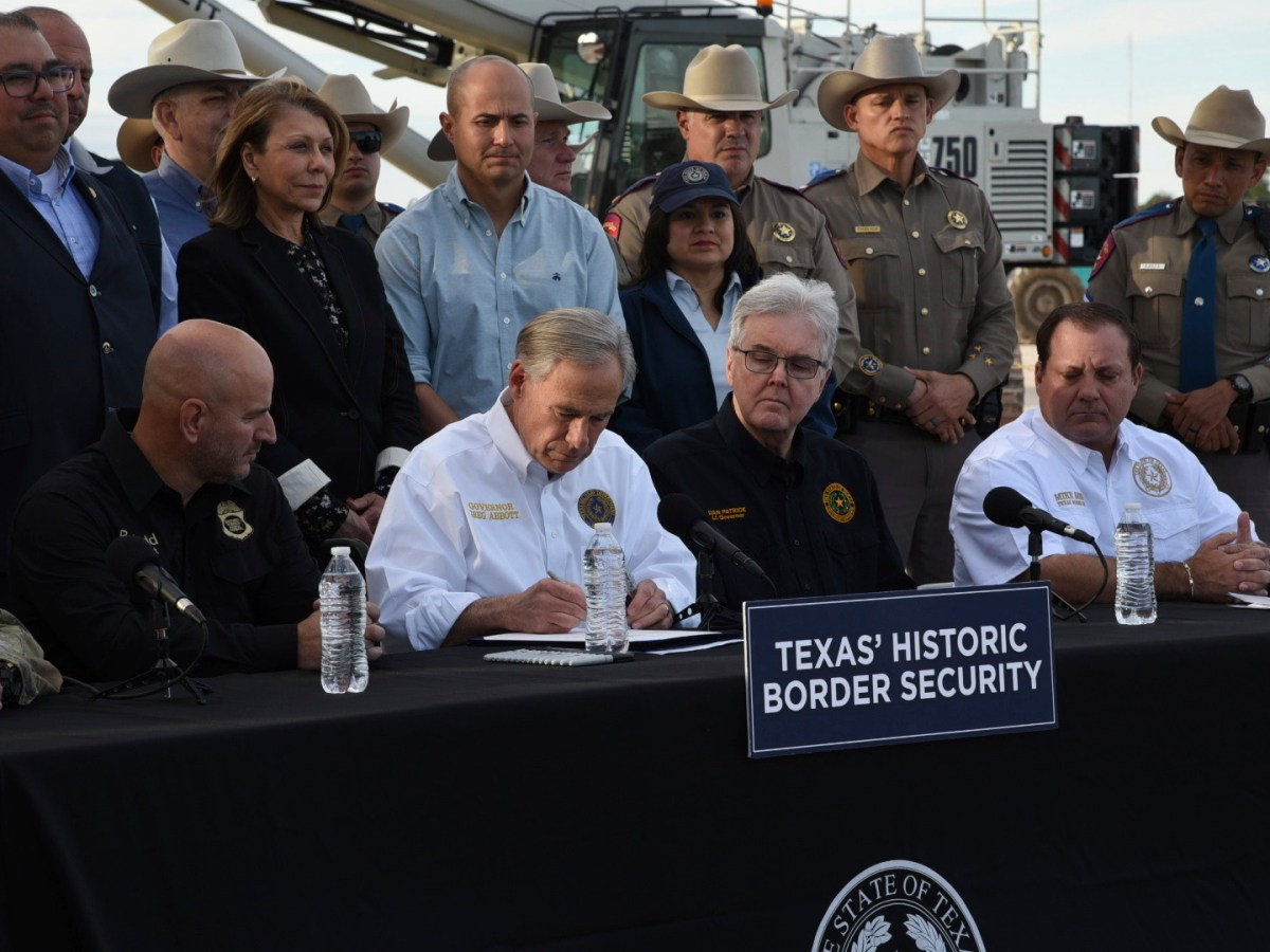 Gov. Greg Abbott signs three bills into law at a border wall construction site in Brownsville, Texas on Monday, Dec. 18, 2023, that will broaden his border security plans and add funding for more infrastructure to deter illegal immigration.